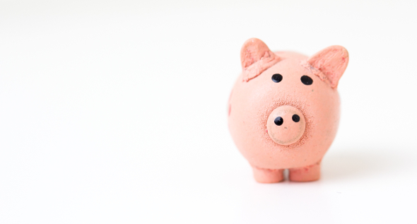 A pink piggy bank on a white background